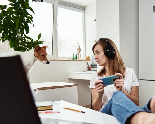 Man sitting on sofa at home working on a laptop